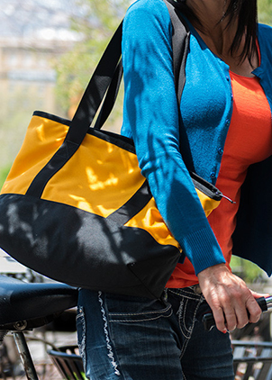 woman with bicycle carrying bag